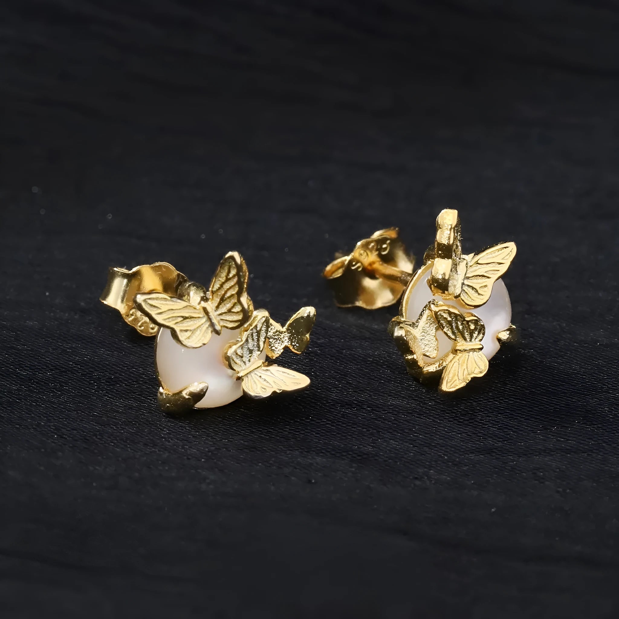A pair of 925 silver butterfly ear studs with an electroplated finish in either white gold or gold colour.