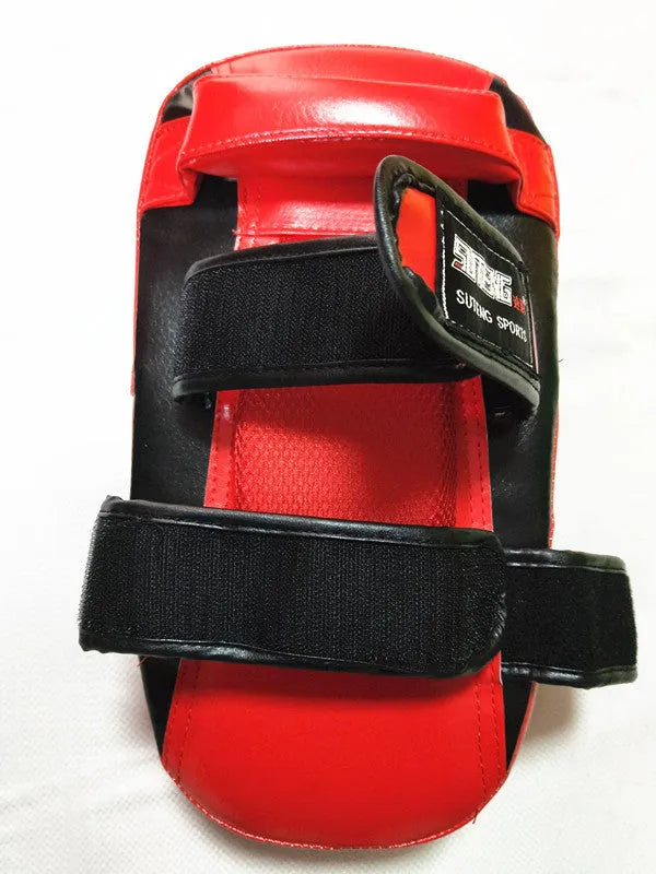 Black with red edges PU leather hand-held boxing target pad showing adhesive buckle strap.