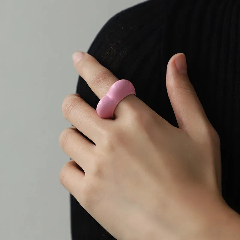 Close-up of a colourful three-dimensional enamel heart ring on a zinc alloy band.