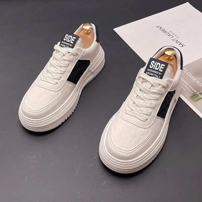 A pair of white green and white black unisex cloth sports casual shoes with a rubber foam sole.