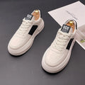 A pair of white green and white black unisex cloth sports casual shoes with a rubber foam sole.