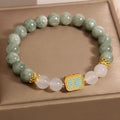 Women's oil green emerald crystal bracelet showing five engraved scripture sections