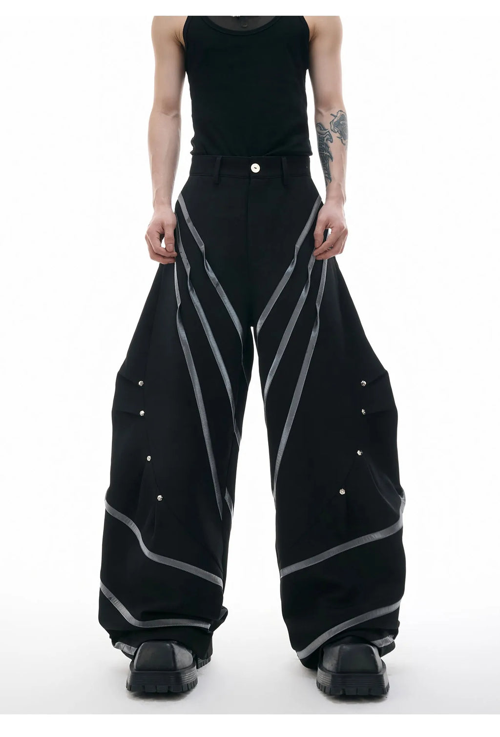Men's black trousers with deconstructed three-dimensional cutting and metal rivets on the pleats