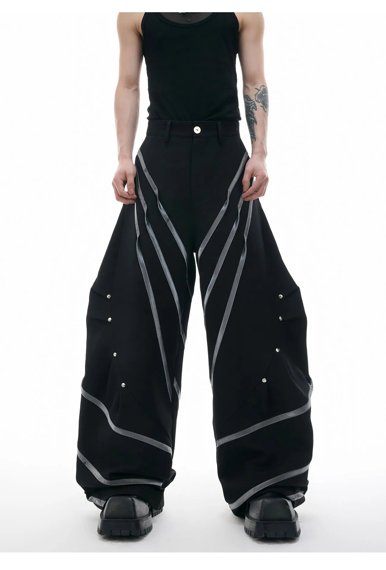 Men's black trousers with deconstructed three-dimensional cutting and metal rivets on the pleats