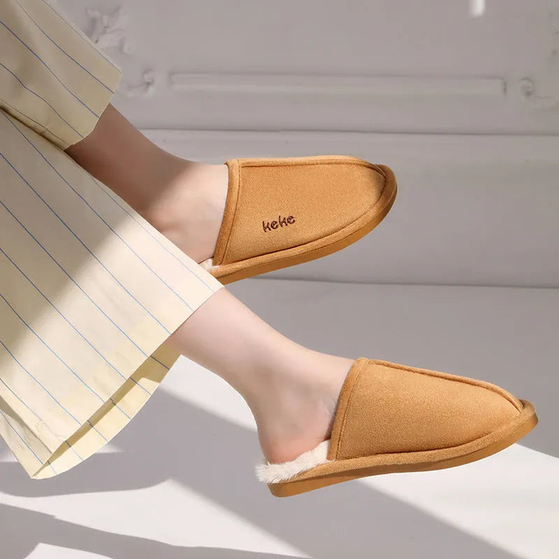 Pair of warm plush cotton slippers with TPR sole in beige on a tiled floor