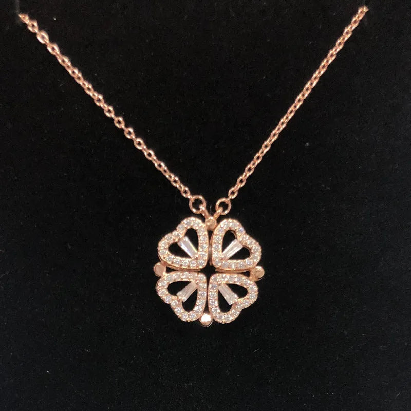 Heart shape four leaf clover pendant necklace in cupronickel 18K gold finish on white background