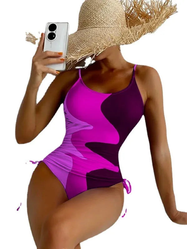 Women's blue sleeveless one-piece swimsuit with fixed trunks and backless design for swimming sports
