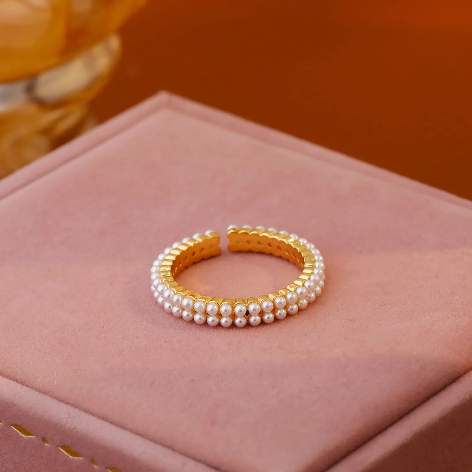 Gold geometric women's ring with open mouth adjustable design and single pearl accent on copper base