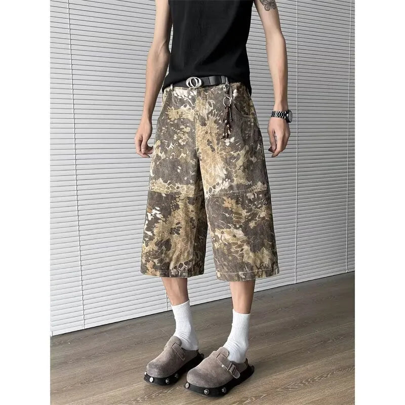 Yellow cotton denim jeans with snake camouflage pattern and cropped leg length.