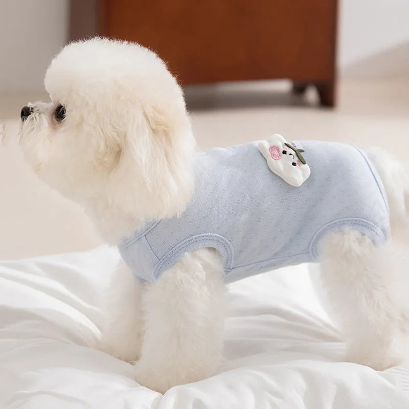 Soft yellow mesh pet shirt with cartoon cat patch and button closure on a small dog or cat