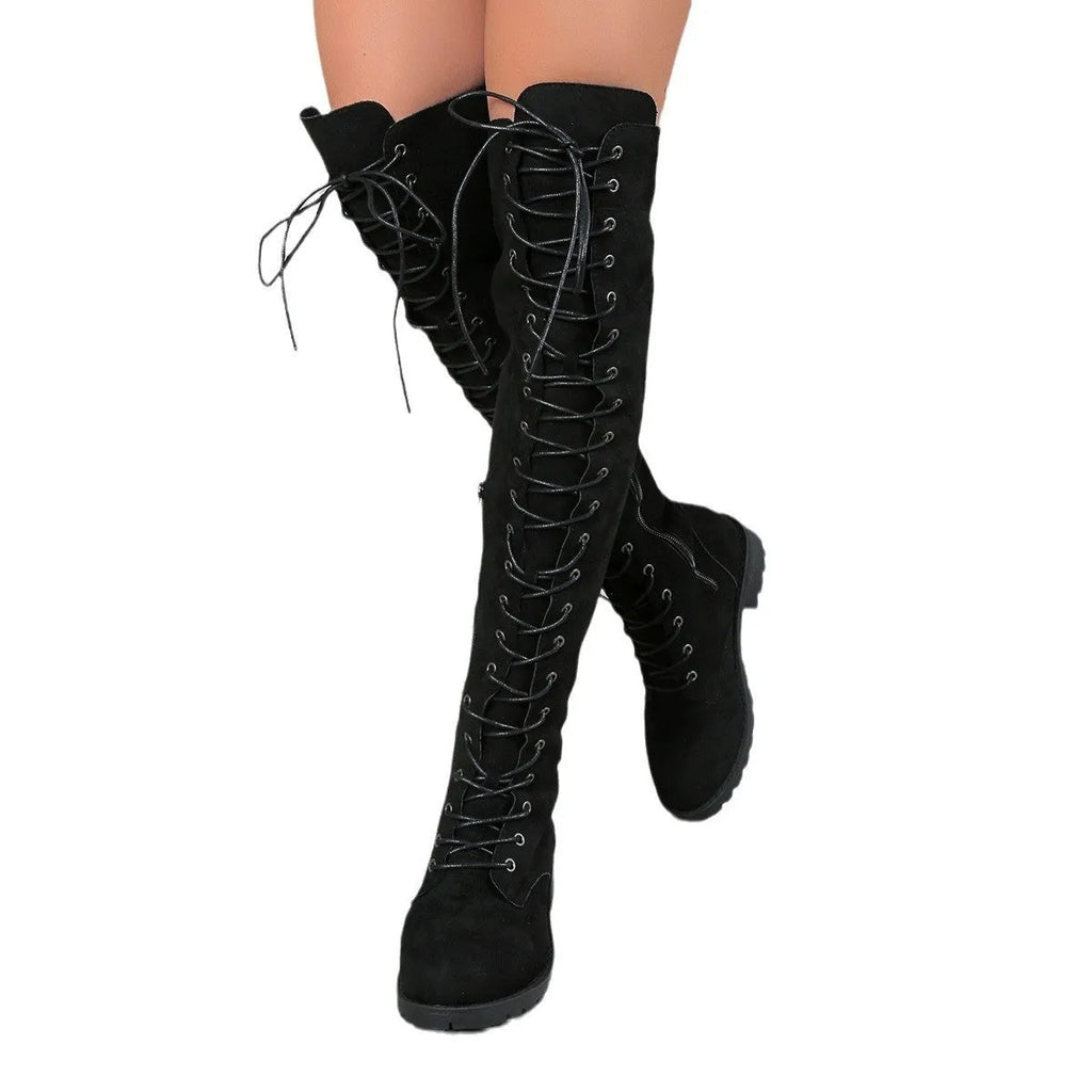 Women's black lace-up over-the-knee boots with stitching detail on a flat rubber sole, shown from the side.
