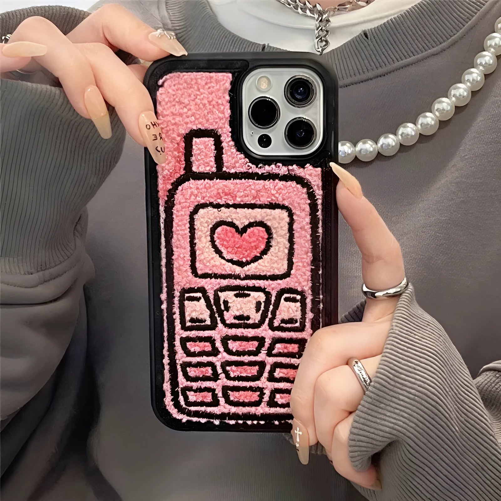 Pink TPU iPhone back cover case with a textured towel embroidered design.