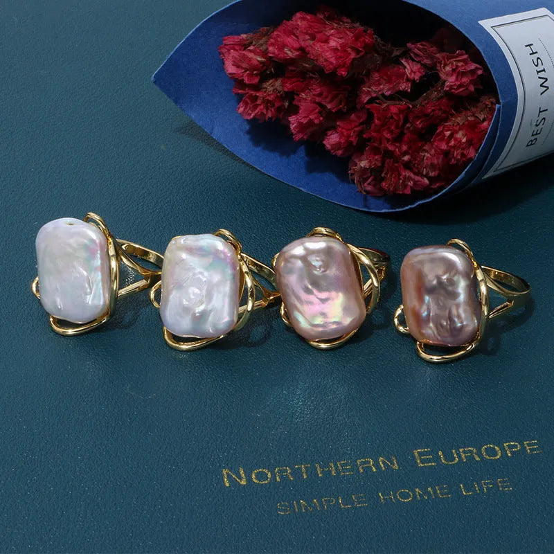 Women's adjustable baroque pearl ring with geometric shape, shown in purple and gold colour options