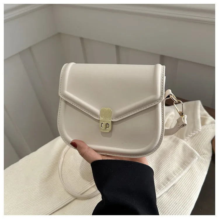 Soft PU leather clamshell messenger bag in a horizontal square shape on a shoulder strap.