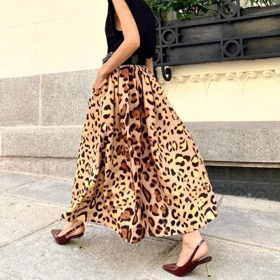 Brown leopard print women's long A-line skirt with a wide, flowing hem on a hanger.