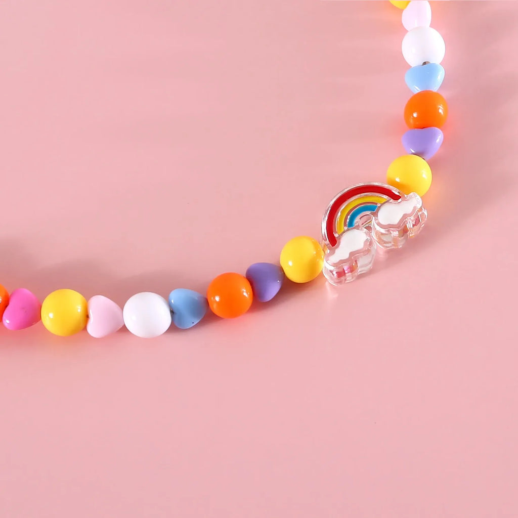 Colourful plastic bead cat necklace on a white background, showing peach, rainbow, and small flower pattern options.