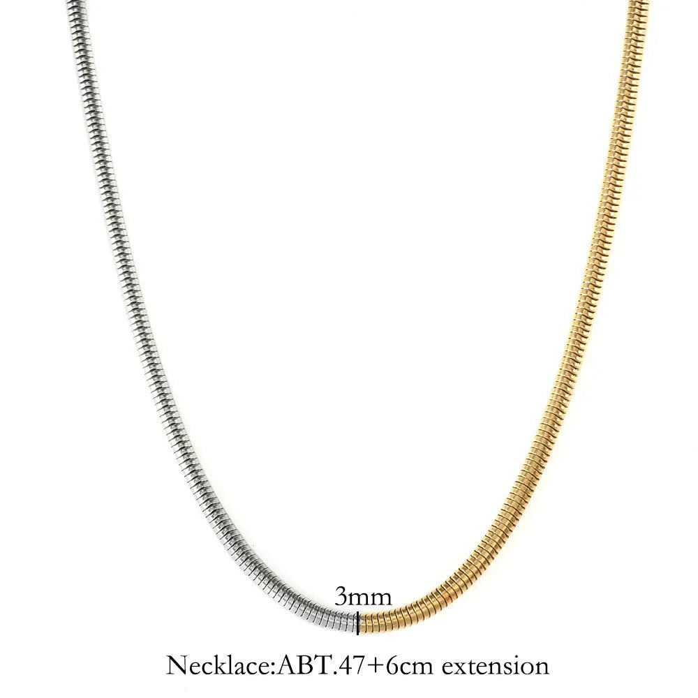 Gold-coloured geometric snake bone chain necklace for women on a white background, showing adjustable extender.