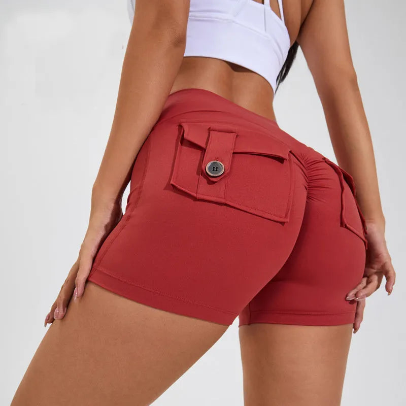 Women's high waist nylon fitness shorts in avocado green with side pockets, laid flat.