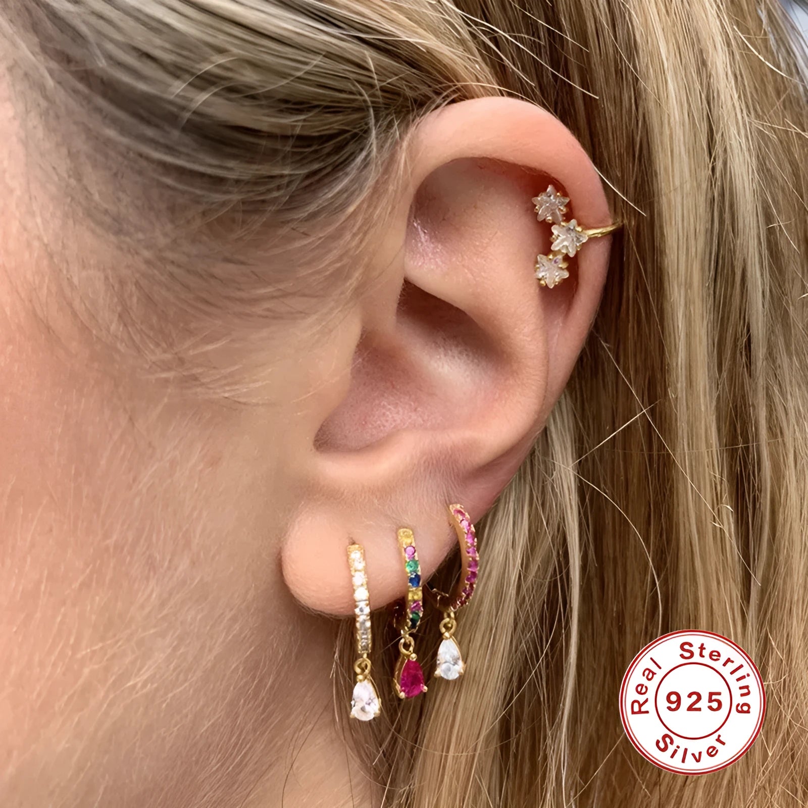 S925 sterling silver water drop shaped earrings with a gemstone accent on a gold or silver background.