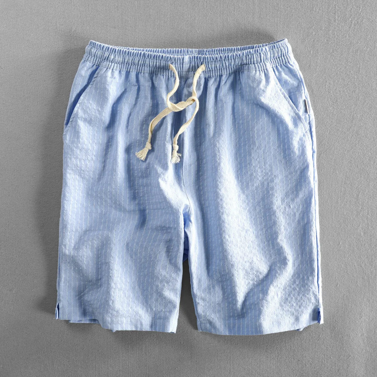 Men's striped casual shorts with elastic waistband in turmeric colour showing loose straight cut