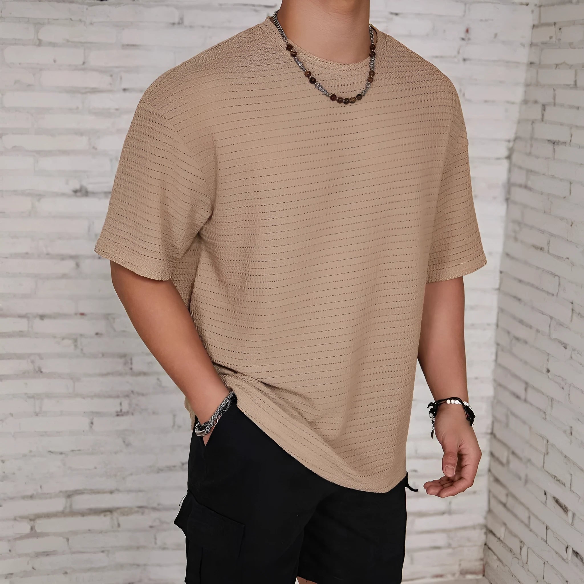 Men's loose slim fit solid colour short sleeve T-shirt in light blue on a grey background.