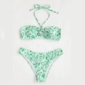 Green floral bandeau bikini swimsuit with split design and adjustable straps on mannequin