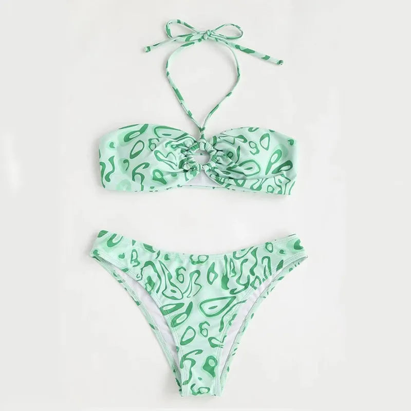 Green floral bandeau bikini swimsuit with split design and adjustable straps on mannequin