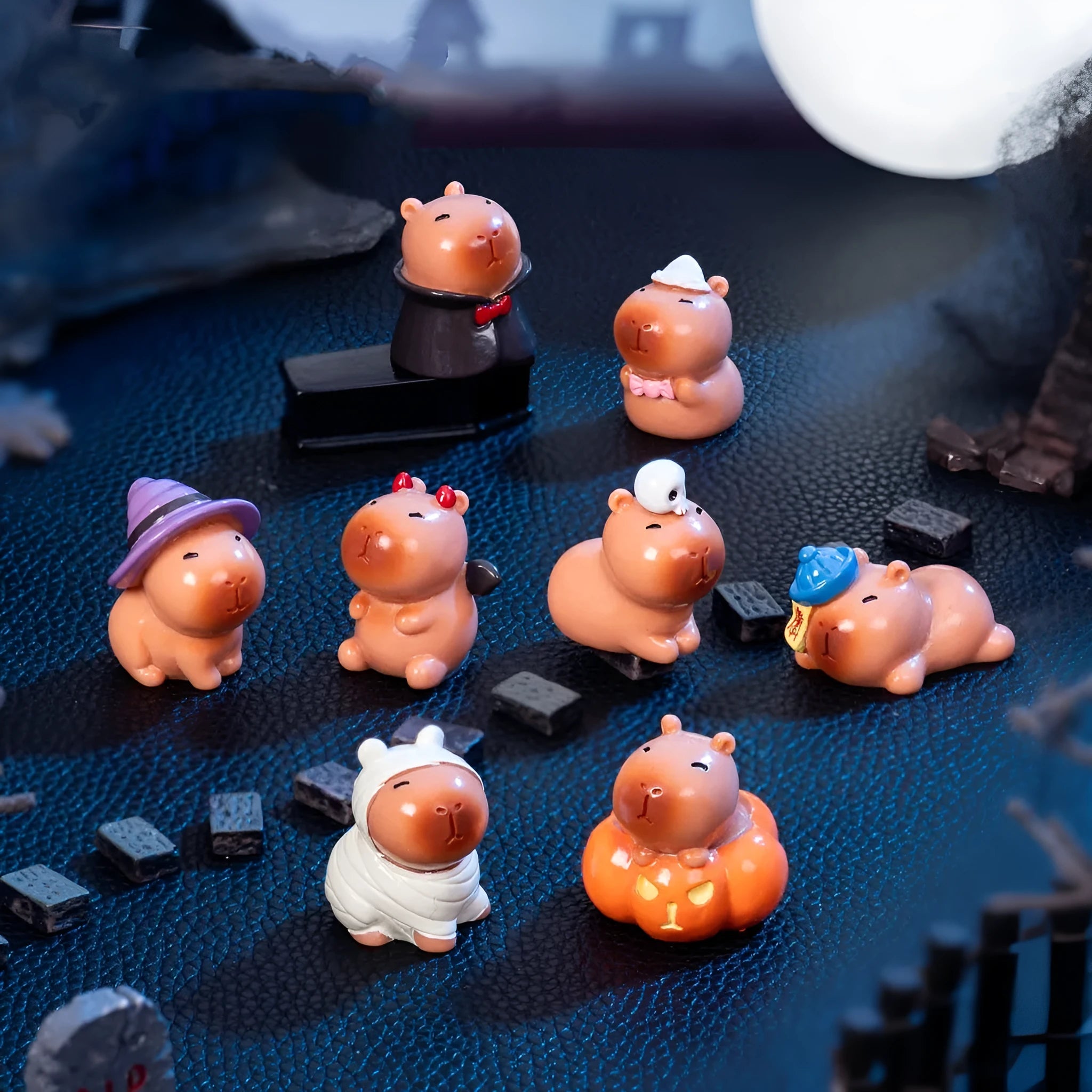 Cute capybara Halloween resin decoration figures in eight different costume designs including pumpkin and vampire.