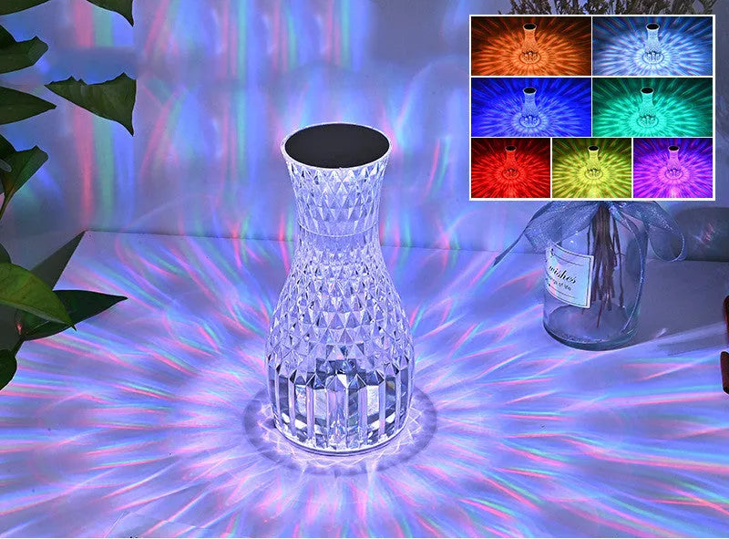 Vase-shaped crystal table lamp with LED lights and remote control on a bedside table