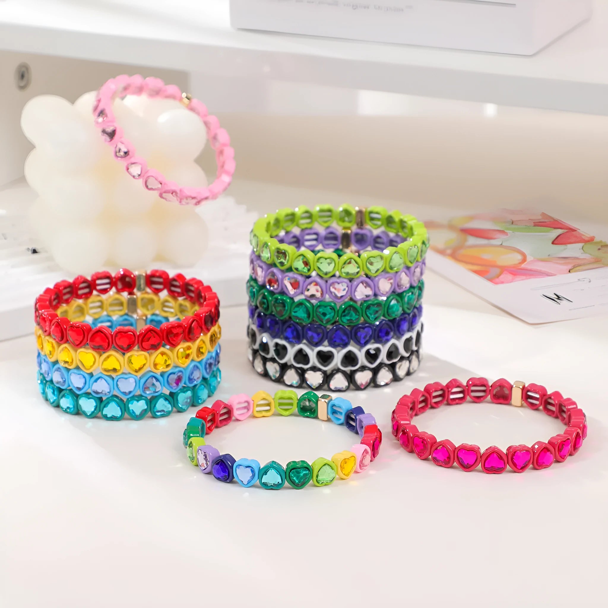Rainbow enamel heart charm bracelet on alloy base with diamond treatment, stretch band, multicolour design.
