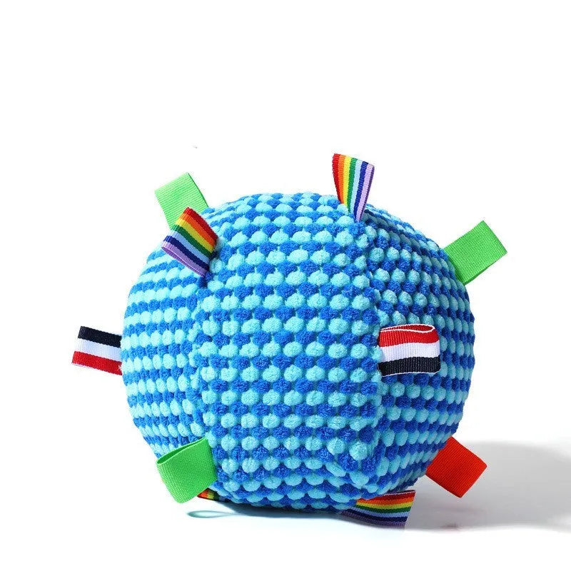 Blue hollow plastic dog ball with pineapple lattice pattern and rattle inside on grass