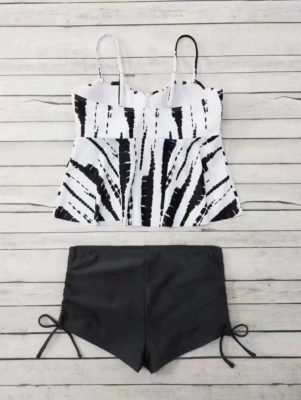 Women's white, blue, and purple polyester bikini swimsuit with matching top and shorts.