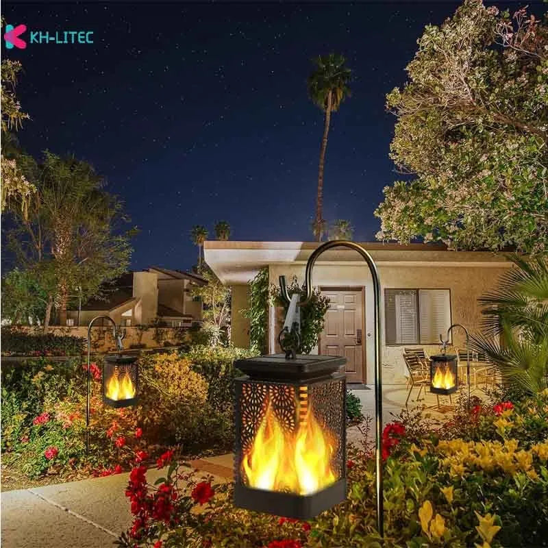 Set of four black solar-powered hanging torch lights with flickering flame LED for outdoor garden use.