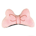 Soft red plush bow tie decoration for helmet customisation, shown against a helmet shell.
