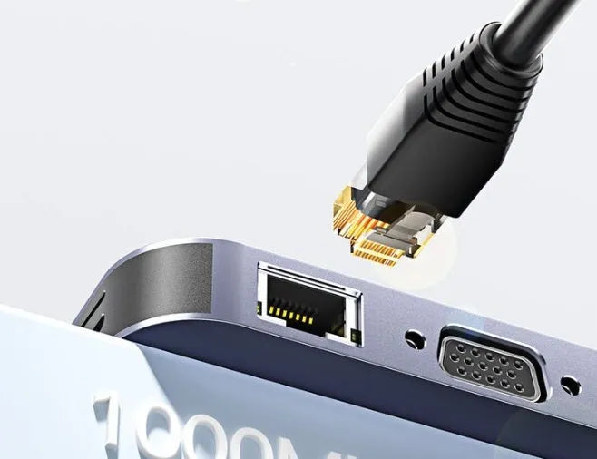 Grey aluminium 11-in-1 USB-C expansion dock hub with attached cable, showing multiple ports including HDMI, VGA, Ethernet, and USB.