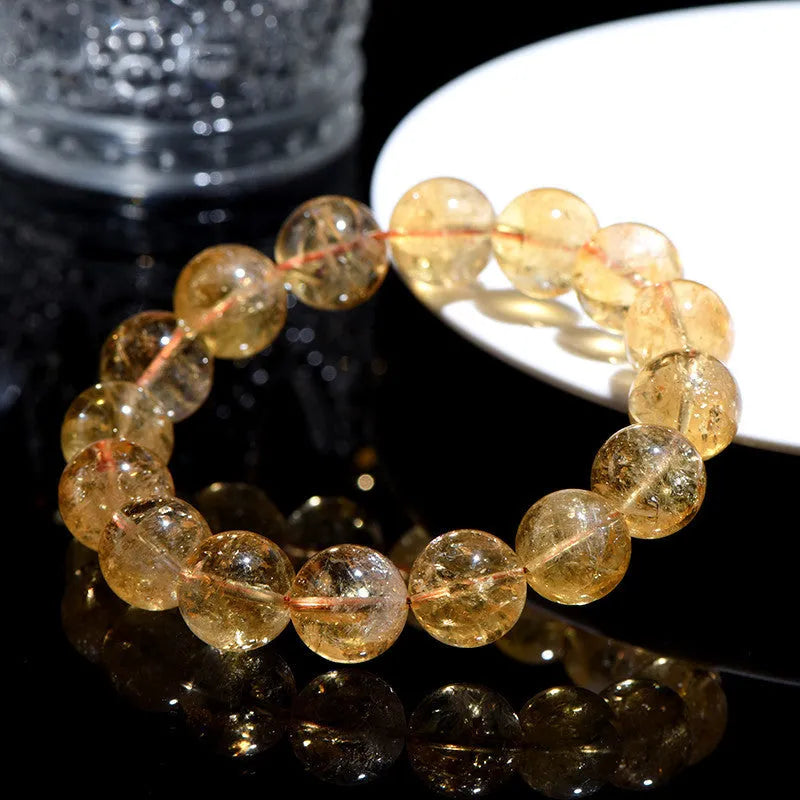 Natural yellow citrine Asestelle bracelet with geometric beads on a wrist.