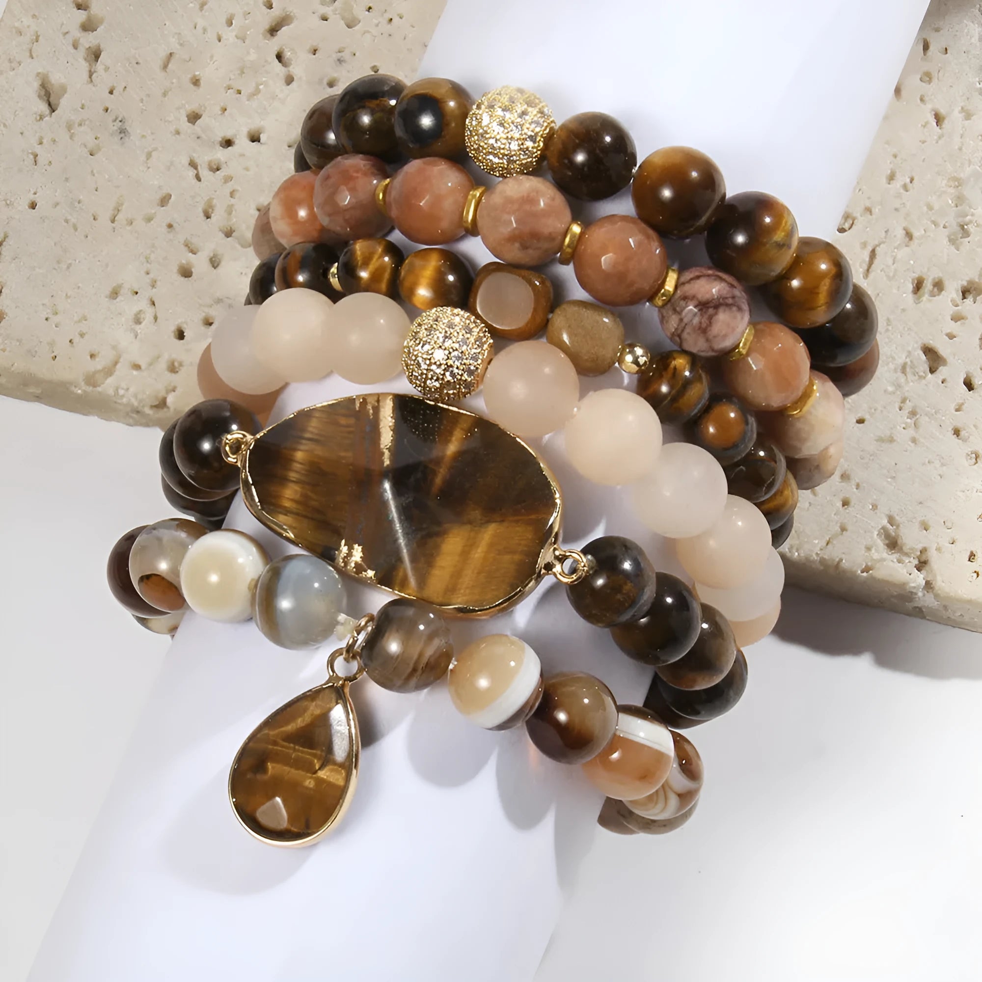 Women's glass beaded stretch bracelet set in brown with natural stone and zircon beads on a white surface