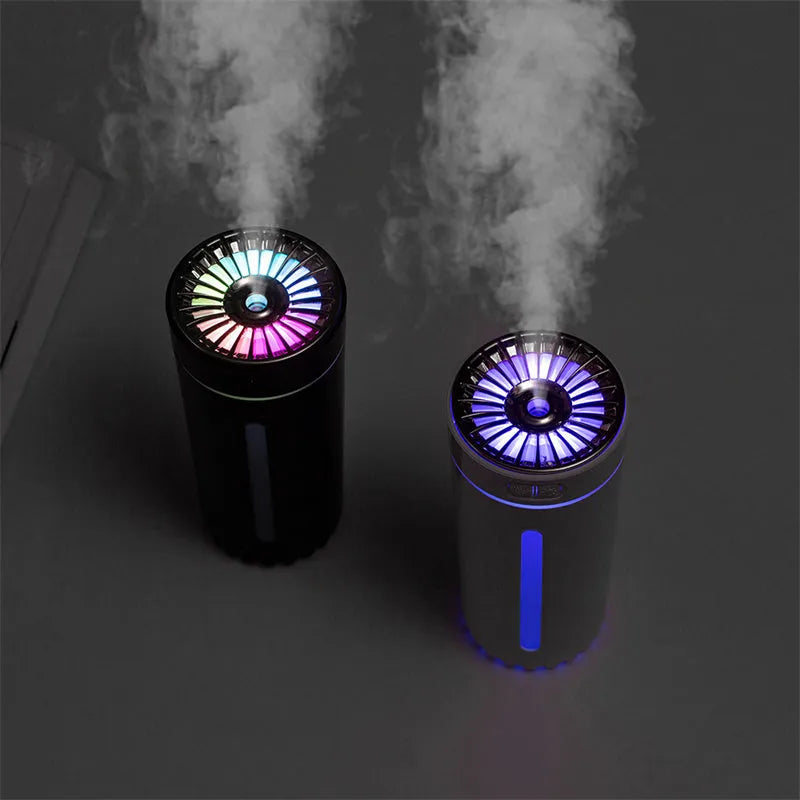 Black portable USB rechargeable humidifier with colourful lights on a car cup holder.