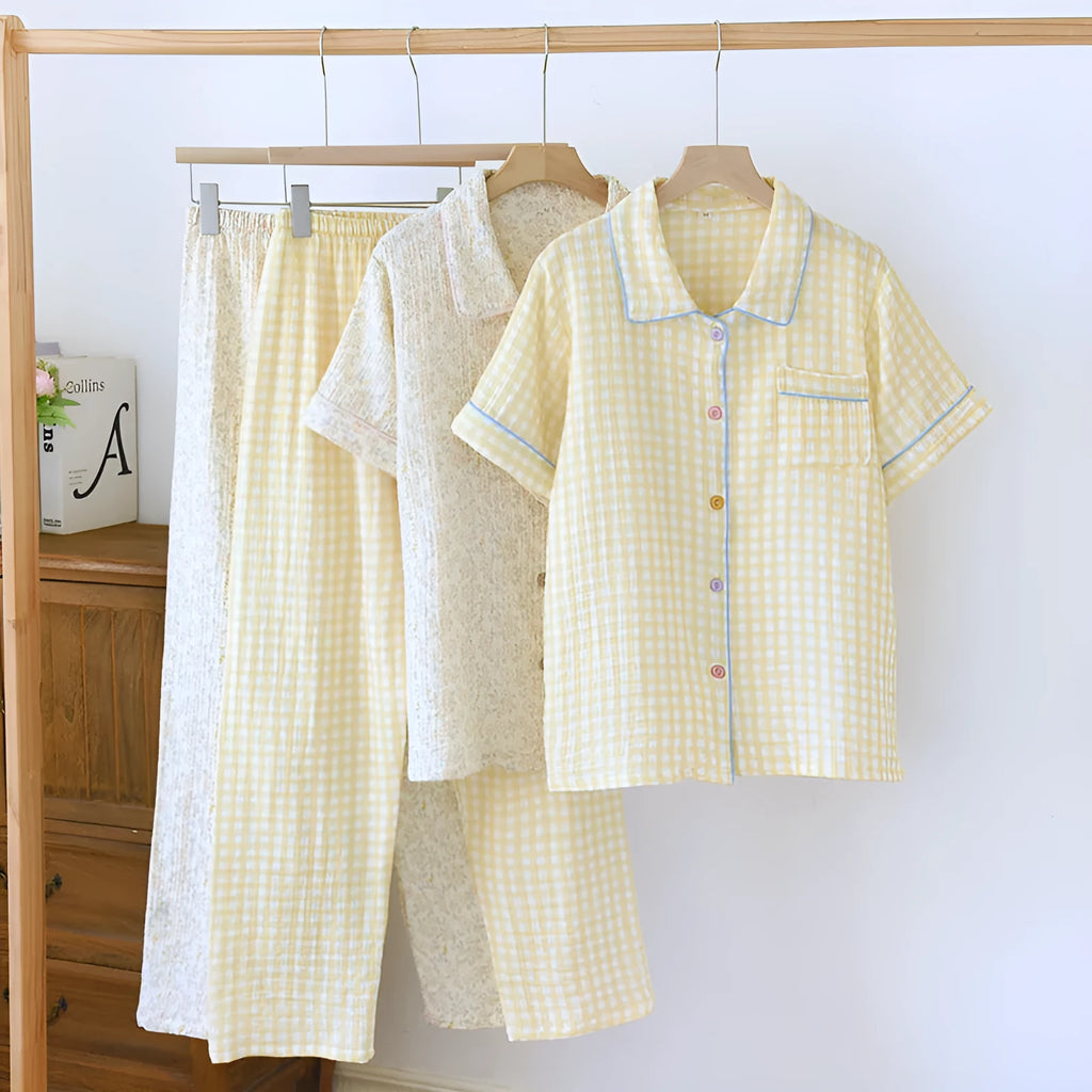 Women's yellow plaid print cotton short-sleeve trouser suit laid flat, showing top and loose-fit trousers.