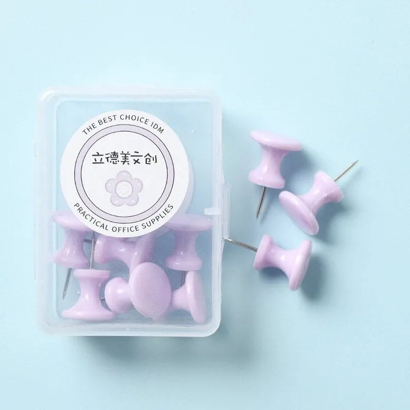 Plastic push pins in cherry blossom pink, mint green, and lavender, showing large and small sizes on a corkboard