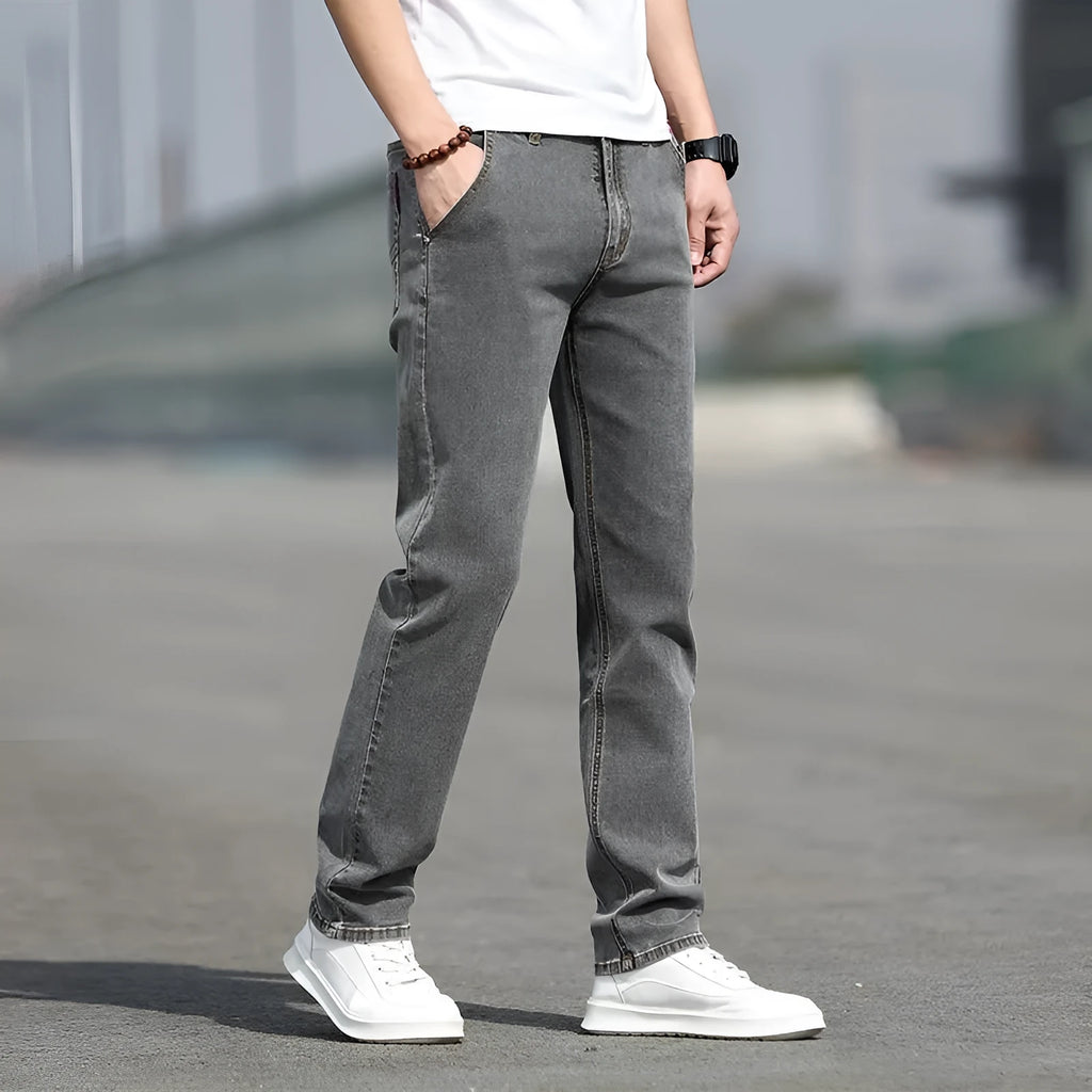 Men's smoky gray straight leg jeans with low waist and zipper fly, made from rabbit fur fabric.
