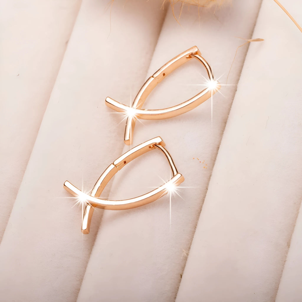 Rose gold plated cross earrings on a white background, showing post and clutch fitting.