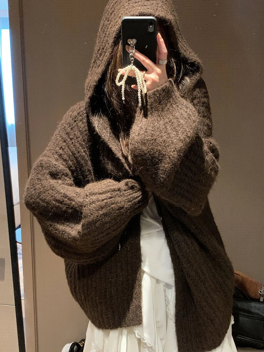 Women's brown retro-style hooded cardigan with a thick knit texture on a hanger.