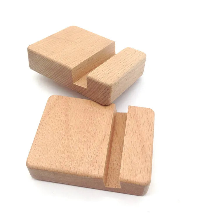 Solid beech wood phone holder with resin puppy decoration and a pound coin in the integrated slot.