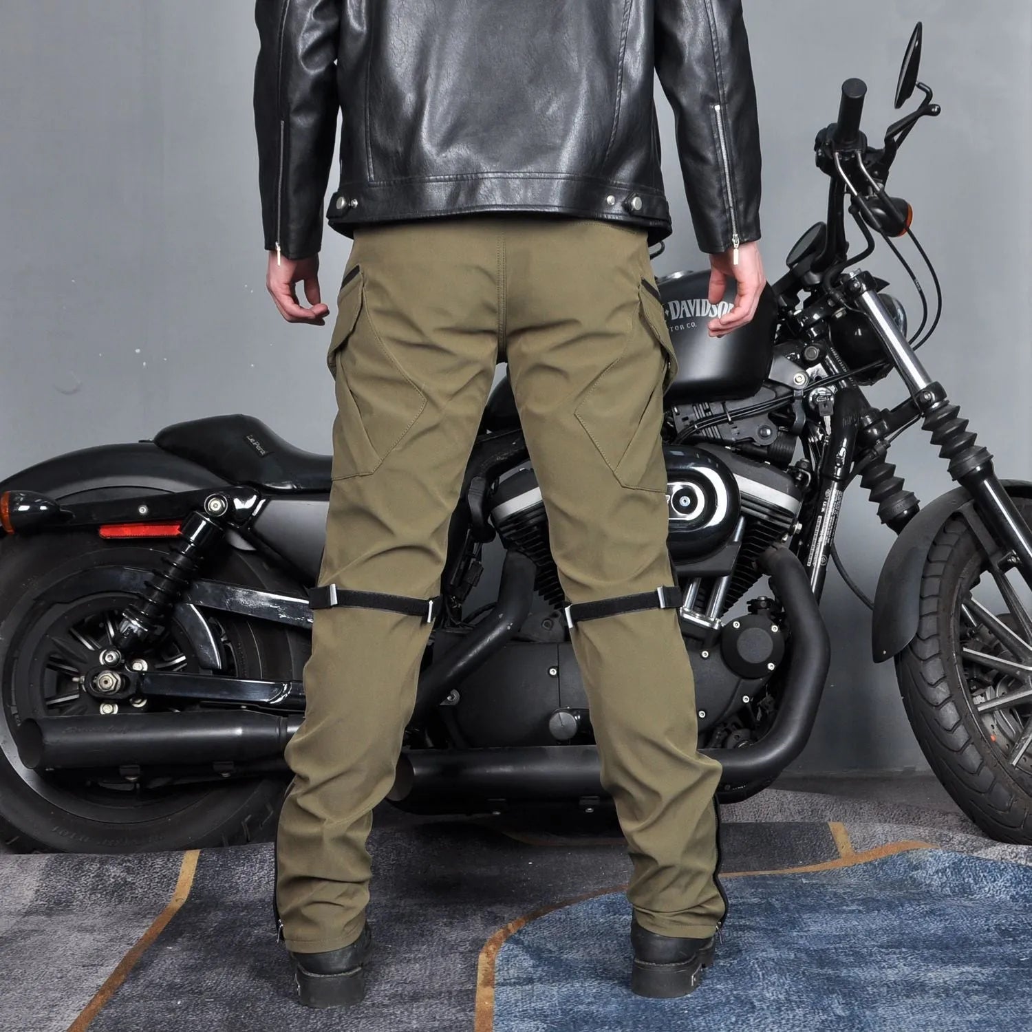 Men's black and green waterproof motorcycle cycling trousers with belt and protective gear.