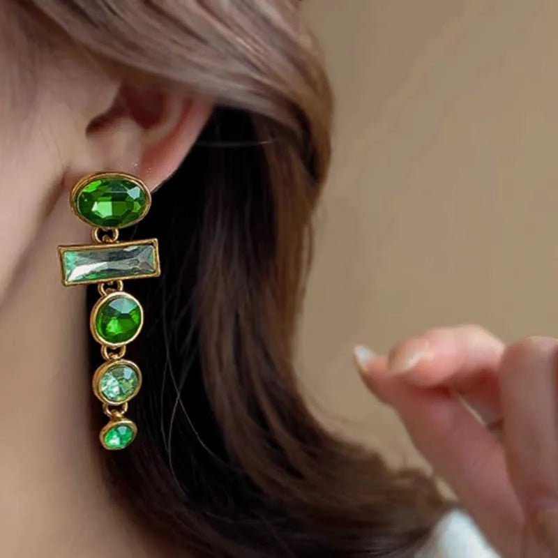 Retro green gradient geometric stud earrings with long silver tassel drop on a white background.