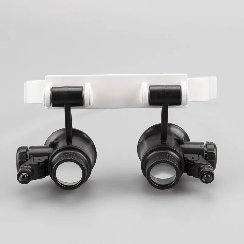 White head-mounted magnifying glass with LED light, shown folded and unfolded, for detailed repair work.