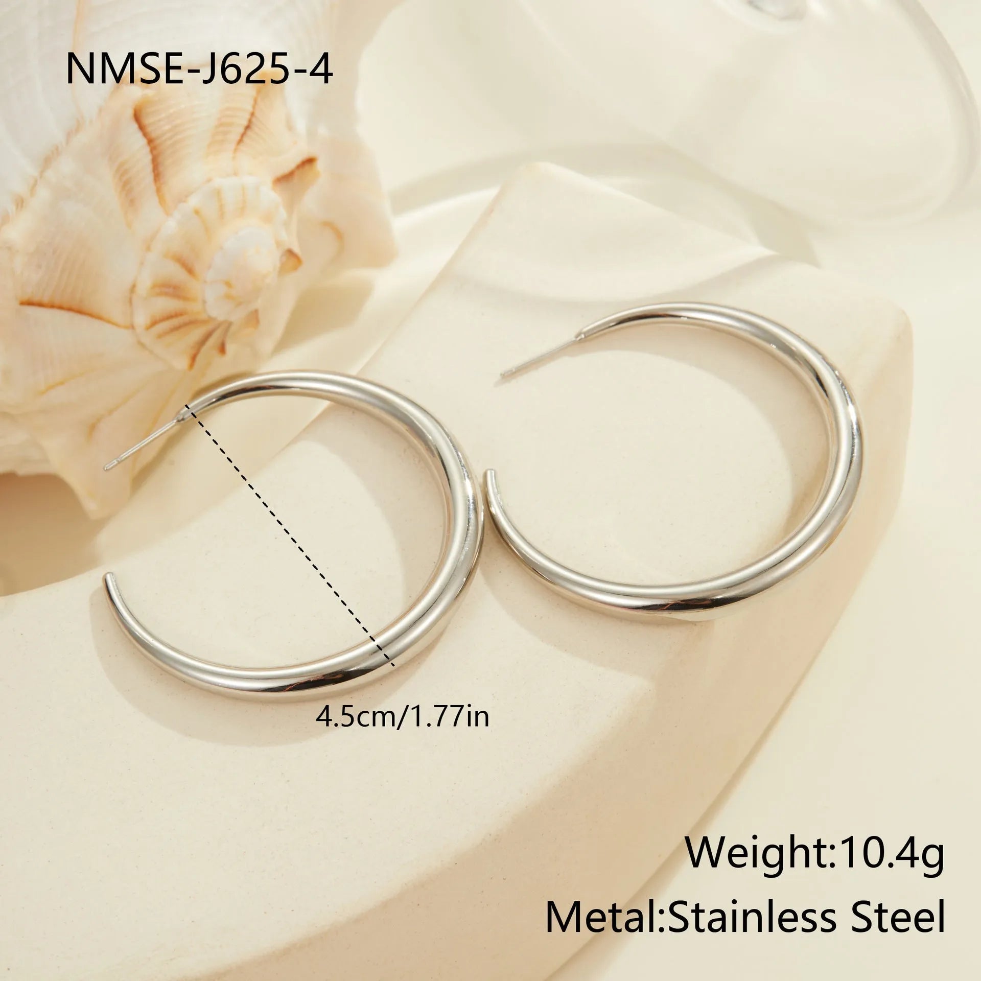Simple titanium steel hoop earrings in gold and steel finishes, available in large and small circular sizes