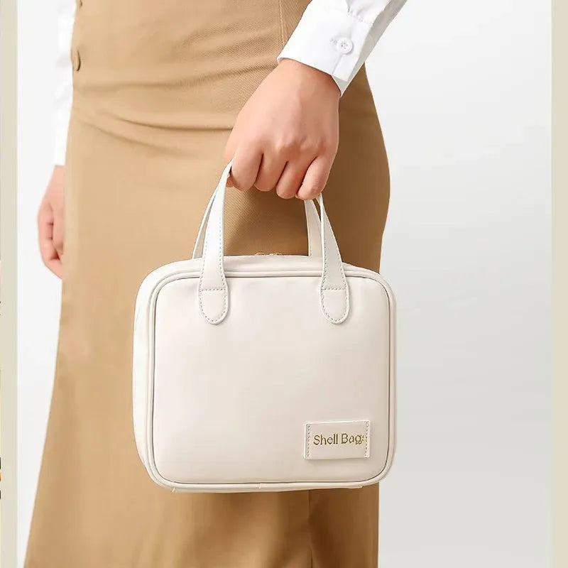 PU leather travel makeup bag in caramel mocha, 21x8x19cm, open to show compartments for cosmetics and toiletries