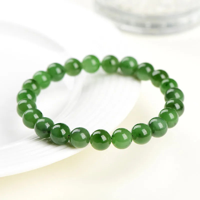 Natural Hetian jade jasper ball bracelet showing polished beads on a wrist.